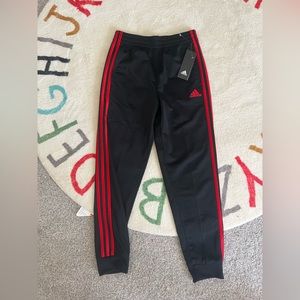 red and black adidas track pants